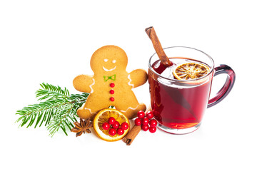 Hot red mulled wine with gingerbread cookie and fir branch isolated on white background with christmas spices, orange slice, anise and cinnamon sticks