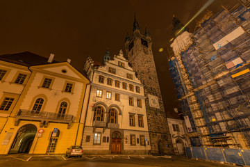 Fototapeta na wymiar Klatovy old city hall and Black tower in autumn night with orange sky