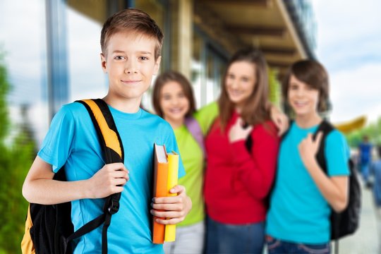 School boy with books and backpack