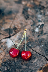 Sweet cherry on a wooden stump background