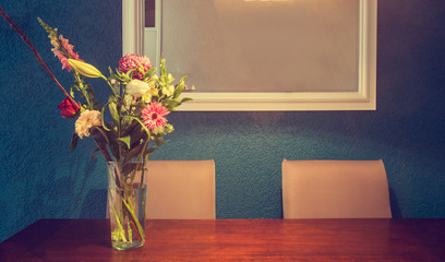 Home interior decor, bouquet and dining table, blue wall texture