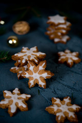 Fototapeta na wymiar Christmas cookies snowflakes and stars on a black background