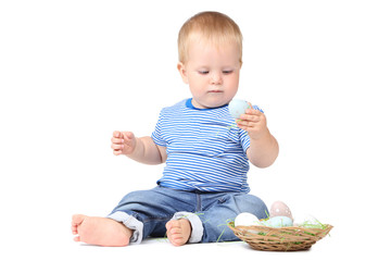Baby boy with easter eggs in basket isolated on white background