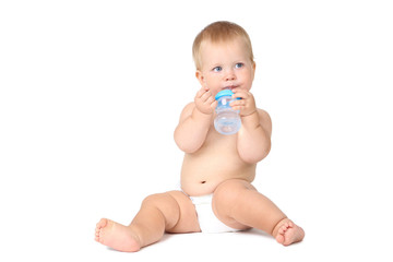 Baby boy drinking water from bottle isolated on white background