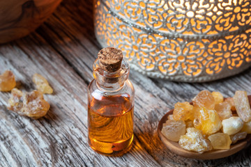 A bottle of frankincense essential oil with frankincense resin