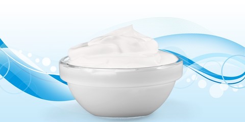 close up of a white beauty cream or yogurt on white background