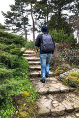 a man with a backpack up the stone steps in the Park