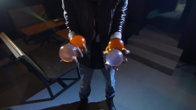 4K Black Magician juggles four balls. Two in each hand
