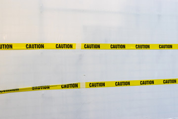 Yellow Plastic Caution Tape Crossed Isolated on White Background.