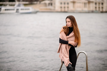 Beautiful girl in autumn day outdoors. Girl with long hair. Art Bay.