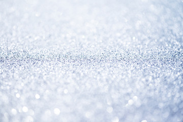Silver glittering christmas lights. Blurred abstract background