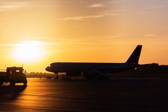 Colorful of sunset in the airport with aeroplane wing, Business and transportation concept.