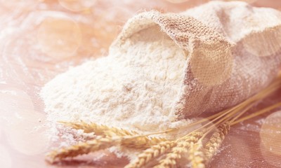 Wheat ears and flour on  background