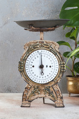 Old vintage kitchen scale on concrete background.