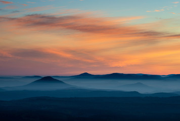 Fototapeta na wymiar Dramatic sunrise over beautiful mountain peaks. Decinsky Sneznik, Czech republic