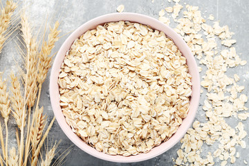 Oatmeal in bowl on grey background