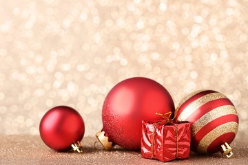 Christmas baubles with gift box on bokeh background