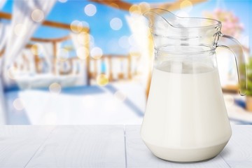 Glass jug of fresh milk isolated on white