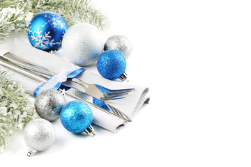 Kitchen cutlery with napkin and christmas decorations on white background