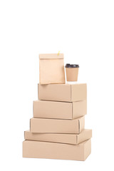 Cardboard boxes with paper bag and cup isolated on white background