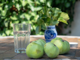 glass of apple juice and green apples