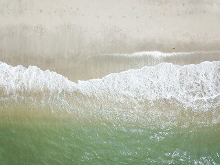 Aerial view of waves on the sandy beach