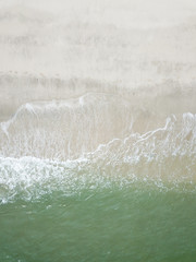 Aerial view of waves on the sandy beach