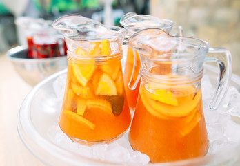 Jugs of lemonade in the ice.