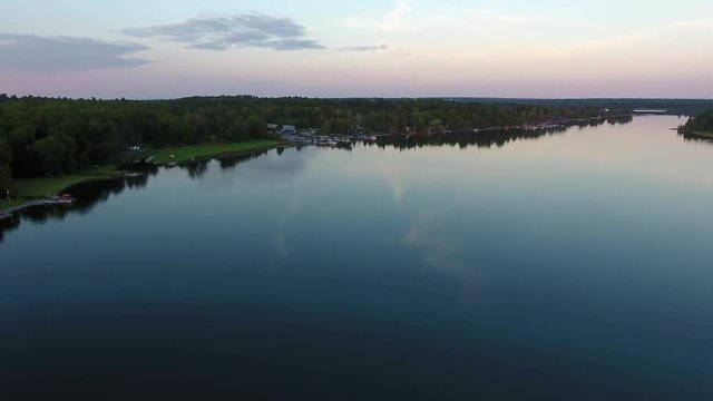 Drone aerial flyover of beautiful scenic lake shoreline
