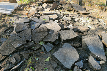 Massive asphalt damage with cracks at street. Broken asphalt in the street. Road repair. Broken road