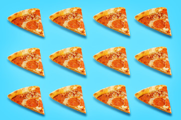 Pizza with pepperoni, tomato sauce and cheese on a blue background
