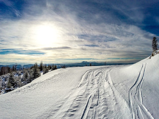 Mountain Road in winter. Beskids Mountains near Radziejowa Mount, Poland. High Tatras in background.