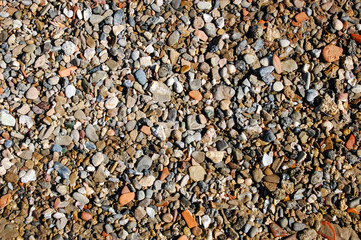 Wet pebbles, stones on the beach - background