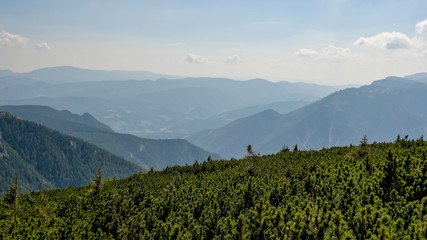 Fototapeta na wymiar The Austrian Alpine mountain landscape on a hazy autumn day.