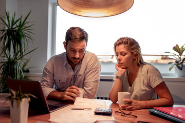 Couple checking their bills at home