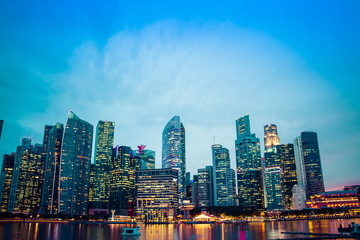 The business District of Singapore across Marina Bay during the blue hour.