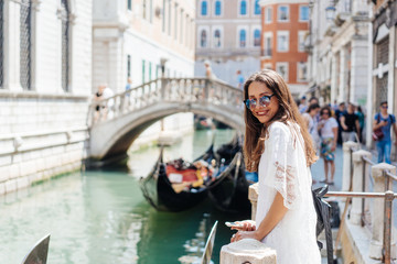 Fototapeta na wymiar Young girl posing on camera in venetian streets