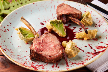 Roasted lamb ribs with berry sauce and broccoli