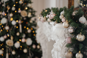 Christmas tree by the fireplace decorated with Christmas decorations