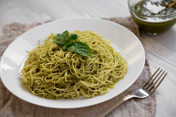 Plate of pasta spaghetti with pesto sauce, low angle view. Close-up.