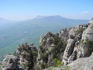 Fototapeta na wymiar Beautiful mountain landscape with sheer cliffs. Distant mountain plateaus in a blue haze. Crimean mountains.