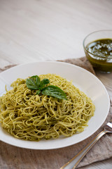 Plate of pasta spaghetti with pesto sauce, low angle view.