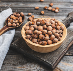 hazelnut nuts in a brown wooden bowl