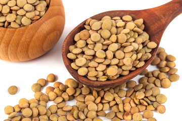 dry lentils on wooden spoon isolated on a white background