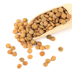 dry lentils on wooden spoon isolated on a white background