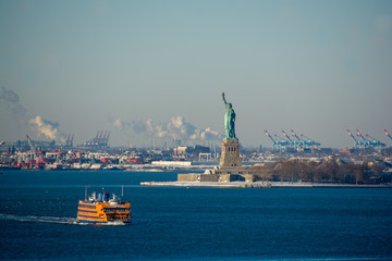 Statue of Liberty seen from Brooklyn on a cold, snowy and sunny winter's day