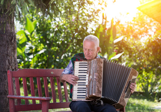 Senior man playing accordion