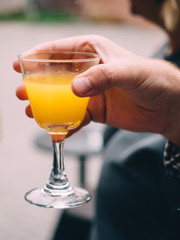 Cocktail in glass in hand. Bar restaurant background