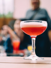 Red alcohol cocktail in glass with ice