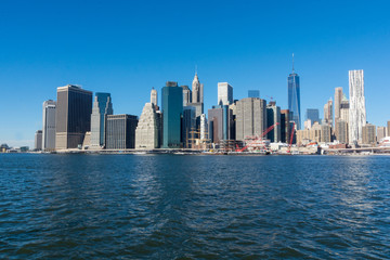 Fototapeta na wymiar Manhattan Island viewed from Brooklyn on a cold and sunny winter day with cloudless blue sky